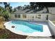 Backyard pool surrounded by lush landscaping with the house and windows in the background at 1204 Duncan Ct, Longwood, FL 32779