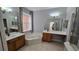 Primary bathroom featuring dual vanities, separate tub, and bright window to let light in at 12126 Diedra Ct, Orlando, FL 32825
