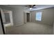 Well-lit bedroom featuring carpet floors, ceiling fan, and storage closet with shelving at 12126 Diedra Ct, Orlando, FL 32825