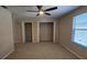 Well-lit bedroom with closet, carpeting, ceiling fan, and plenty of space for furnishings at 12126 Diedra Ct, Orlando, FL 32825