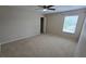 Comfortable bedroom featuring a ceiling fan, neutral walls, and carpeting throughout at 12126 Diedra Ct, Orlando, FL 32825