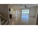 Open-concept living area adjacent to the kitchen with tile flooring and sliding glass door to patio at 12126 Diedra Ct, Orlando, FL 32825