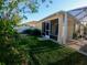 Backyard with lush garden and screen-enclosed lanai at 1221 Santa Cruz Dr, The Villages, FL 32162