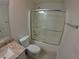 Well-lit bathroom with a glass shower, vanity, and white ceramic toilet at 1221 Santa Cruz Dr, The Villages, FL 32162