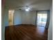 Bright bedroom with hardwood floors, ceiling fan, and sliding glass doors to the lanai at 1221 Santa Cruz Dr, The Villages, FL 32162