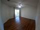 Bedroom featuring hardwood floors, ceiling fan, and access to the screened-in patio at 1221 Santa Cruz Dr, The Villages, FL 32162