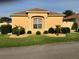 Inviting single-story home featuring manicured lawn, rock landscaping, and a bright, sunny facade at 1221 Santa Cruz Dr, The Villages, FL 32162