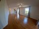 Bright and spacious living room with polished hardwood floors and updated light fixtures at 1221 Santa Cruz Dr, The Villages, FL 32162
