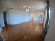 Expansive living room with hardwood flooring, natural light, and modern chandelier at 1221 Santa Cruz Dr, The Villages, FL 32162