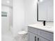 Bathroom with a single vanity with gray cabinetry and white countertop at 13525 Se 100Th Ave, Belleview, FL 34420