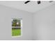Bedroom with large window and view of the lawn and trees at 13525 Se 100Th Ave, Belleview, FL 34420