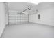 Spacious garage with a roll-up door and sealed concrete flooring at 13525 Se 100Th Ave, Belleview, FL 34420