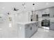 Open-concept kitchen with stainless appliances, large island, and gray cabinets on marble floors at 13525 Se 100Th Ave, Belleview, FL 34420