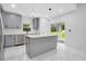 Stylish kitchen with gray cabinets, a center island, and stainless steel appliances at 13525 Se 100Th Ave, Belleview, FL 34420