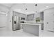 This is a kitchen with grey cabinets, stainless steel appliances, and an island at 13525 Se 100Th Ave, Belleview, FL 34420