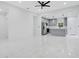Spacious living room featuring an adjacent modern kitchen and sleek fixtures at 13525 Se 100Th Ave, Belleview, FL 34420