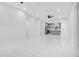 Bright, open-concept living area with modern gray kitchen and marble flooring at 13525 Se 100Th Ave, Belleview, FL 34420