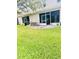 Spacious backyard with mature trees, patio and green grass at 14033 Turning Leaf Dr, Orlando, FL 32828