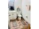 Cozy half-bath features patterned rugs, modern vanity, updated fixtures and decor at 14033 Turning Leaf Dr, Orlando, FL 32828