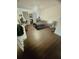 Spacious bedroom with dark wood floors, a bed, and a desk area; bright and airy at 14033 Turning Leaf Dr, Orlando, FL 32828