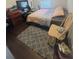 Bedroom with wood floors, gray rug, simple decor, and a window providing natural light at 14033 Turning Leaf Dr, Orlando, FL 32828