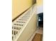 Staircase showcasing wooden banister and white rails, leading to the upper level of the home at 14033 Turning Leaf Dr, Orlando, FL 32828
