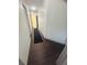 Hallway with modern lighting, wood-look flooring and neutral walls at 14033 Turning Leaf Dr, Orlando, FL 32828