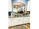 Well-equipped kitchen featuring stainless steel sink, white cabinets, granite countertops, and views into dining area at 14033 Turning Leaf Dr, Orlando, FL 32828