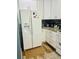 Bright kitchen featuring white cabinetry, granite countertops, modern appliances, and tile backsplash at 14033 Turning Leaf Dr, Orlando, FL 32828