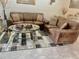 Warm, inviting living room features two sofas, decorative pillows and a unique glass coffee table at 14033 Turning Leaf Dr, Orlando, FL 32828
