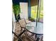Relaxing screened patio features a blue accent wall, seating and a blue glass top table at 14033 Turning Leaf Dr, Orlando, FL 32828