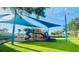 Community playground featuring colorful slides, swings, and covered play area for hours of outdoor fun at 14033 Turning Leaf Dr, Orlando, FL 32828