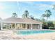 Inviting pool with poolside cabana, offering shade and seating for a relaxing day by the water at 14033 Turning Leaf Dr, Orlando, FL 32828