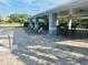 Inviting covered poolside lounge area with ample seating, ideal for relaxing and socializing by the pool at 14033 Turning Leaf Dr, Orlando, FL 32828