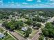 Overhead view of the property showcasing the home, outbuildings, surrounding trees, and neighborhood layout at 141 S Central Ave, Apopka, FL 32703