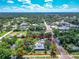Expansive aerial view of this property with a large lot surrounded by mature trees and neighborhood streets at 141 S Central Ave, Apopka, FL 32703