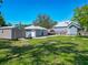 View of the spacious backyard featuring a shed, additional structure, and the home's exterior at 141 S Central Ave, Apopka, FL 32703