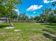 Expansive backyard with lush lawn, ideal for recreation, landscaping, and outdoor activities at 141 S Central Ave, Apopka, FL 32703