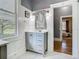 Elegant bathroom with gray vanity, marble counters, stylish mirror, and a view of the bedroom at 141 S Central Ave, Apopka, FL 32703