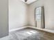 This vacant room features neutral walls, plush carpeting, a ceiling fan, and a window with neutral curtains at 141 S Central Ave, Apopka, FL 32703