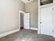 Empty room boasts neutral walls, plush carpeting, a ceiling fan, and white doors for storage at 141 S Central Ave, Apopka, FL 32703