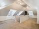 Spacious attic bonus room with dormer windows and neutral carpeting, ready for customization at 141 S Central Ave, Apopka, FL 32703
