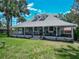 Charming home featuring a spacious porch, well-manicured lawn, and classic architectural details for curb appeal at 141 S Central Ave, Apopka, FL 32703