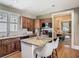 Bright kitchen featuring granite countertops, a breakfast bar, stainless steel appliances and charming, natural wood cabinets at 141 S Central Ave, Apopka, FL 32703