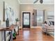 Inviting living room with gleaming hardwood floors, and sunlit windows, perfect for relaxing or entertaining guests at 141 S Central Ave, Apopka, FL 32703