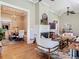 Spacious living room with gleaming hardwood floors, fireplace, and an open view into the dining room at 141 S Central Ave, Apopka, FL 32703