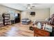 Multipurpose living space with hardwood floors, couch, television, ceiling fan and window at 141 S Central Ave, Apopka, FL 32703