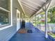 Charming porch with white columns, dark blue painted deck, showcasing outdoor living space at 141 S Central Ave, Apopka, FL 32703