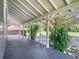 Inviting side porch with dark wood flooring and lush greenery at 141 S Central Ave, Apopka, FL 32703