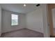 Simple bedroom design with a window letting in natural light and neutral walls at 1429 Discovery St, Davenport, FL 33896
